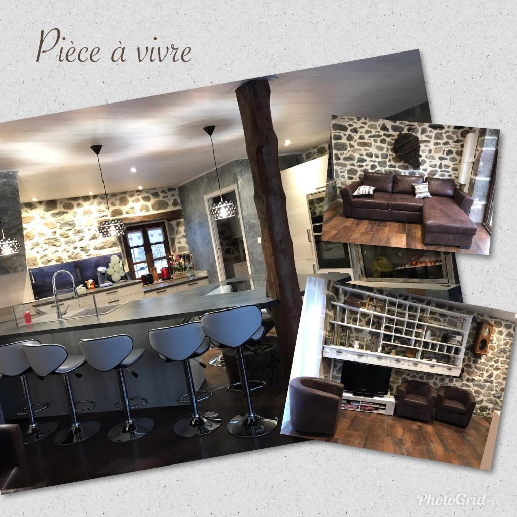 - une vue sur une cuisine avec un bar et un canapé dans l'établissement la petite forge, à Saint-Saturnin