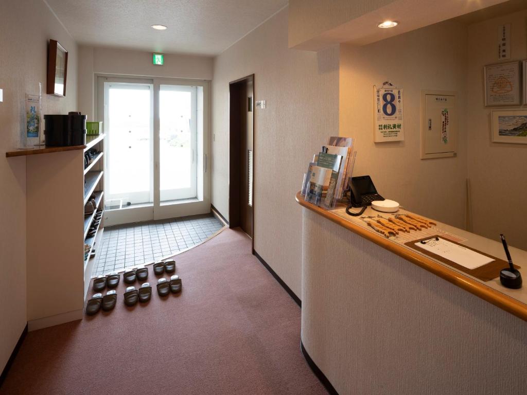 une chambre avec un comptoir et des chaussures au sol dans l'établissement Shimanoyado Rebunshiri, à Rebun