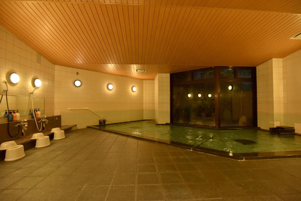- une piscine dans un bâtiment avec piscine dans l'établissement Miyajima Morinoyado, à Miyajima