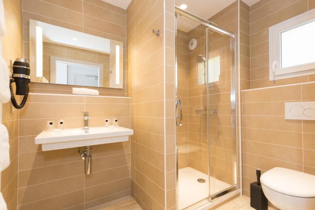 une salle de bain avec une douche, un lavabo et des toilettes dans l'établissement Hôtel-Restaurant Bois Joly, à Crozet