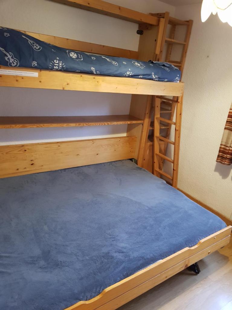 Ce lit se trouve dans un dortoir doté de 2 lits superposés et d'un matelas bleu. dans l'établissement Serrecheholidays, à Serre Chevalier