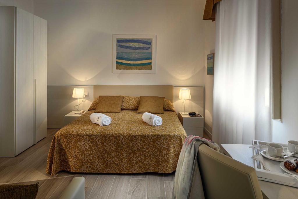 une chambre avec un lit avec deux serviettes dessus dans l'établissement Hotel Astoria, à Bibione 112 autres photos