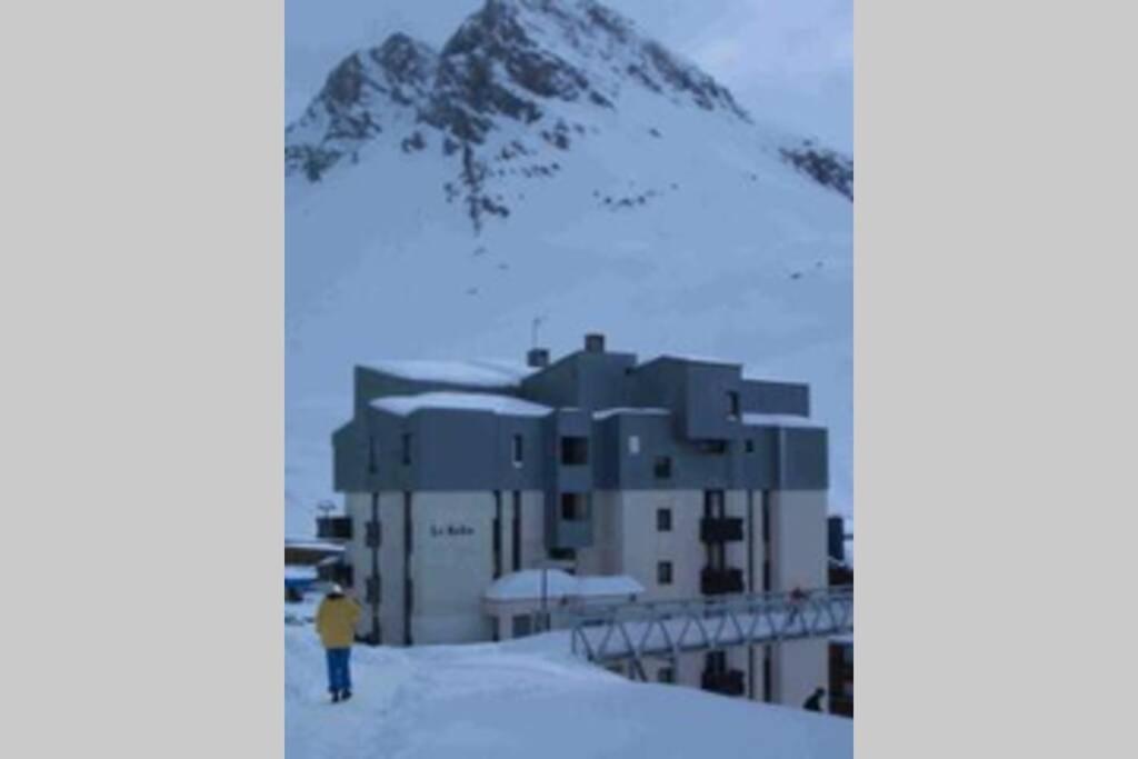 un homme debout au sommet d'une montagne enneigée dans l'établissement Residence Bollin No.21, à Tignes