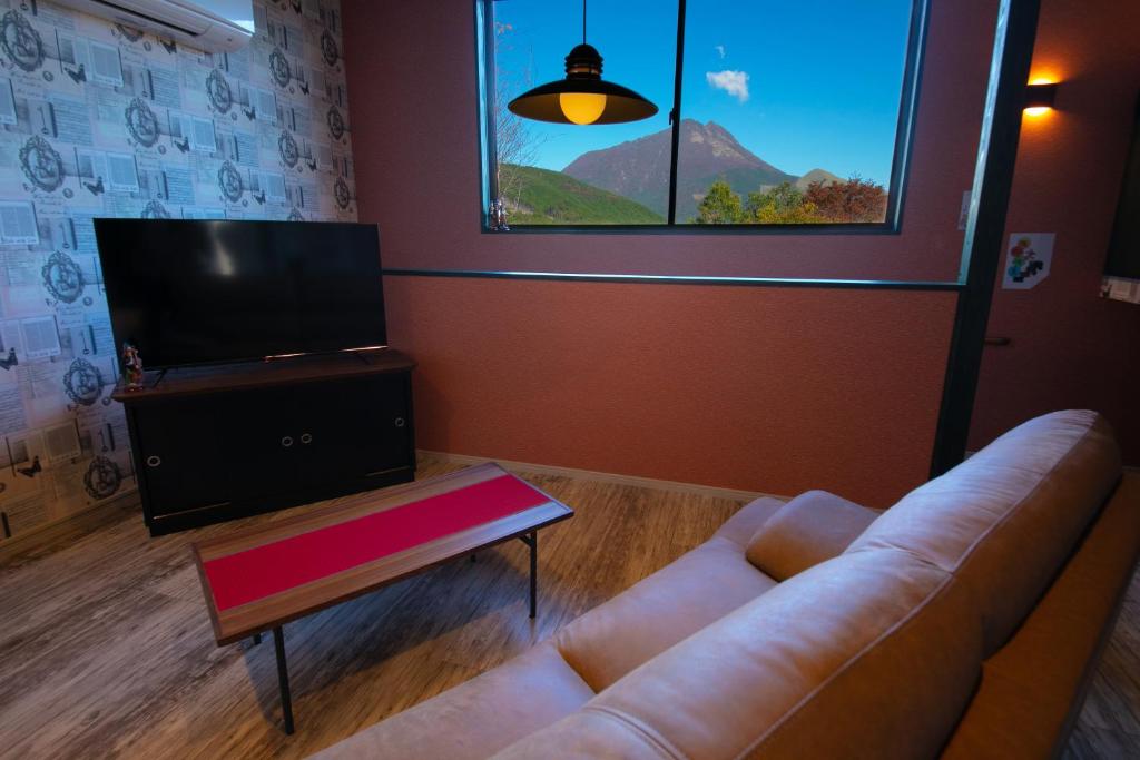 un salon avec un canapé et une télévision à écran plat dans l'établissement Innter Hill Tsubasa Yufuin, à Yufu 24 autres photos