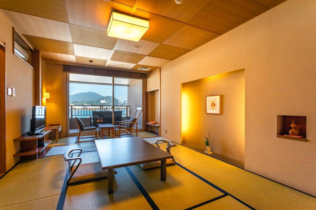 un salon avec une table et une salle à manger dans l'établissement Migiwaya, à Yaizu