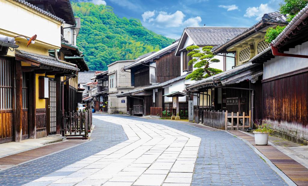 une rue vide dans une vieille ville avec des bâtiments dans l'établissement NIPPONIA HOTEL Takehara Saltworks Town, à Takekara