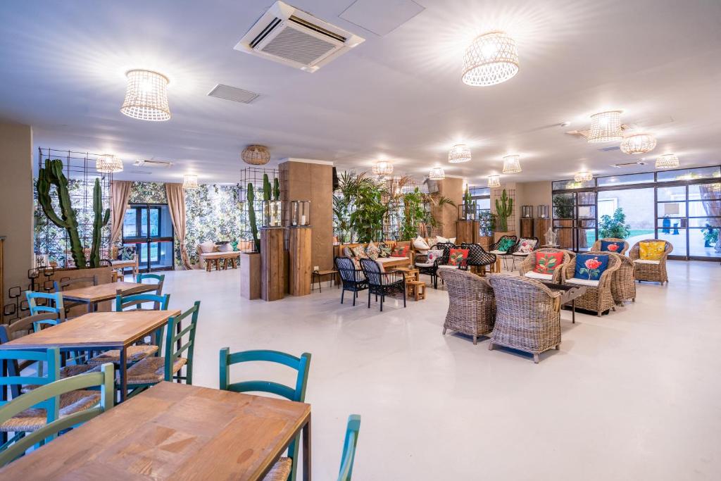 un restaurant avec des tables et des chaises dans une salle dans l'établissement Capo Peloro Hotel, à Torre Faro