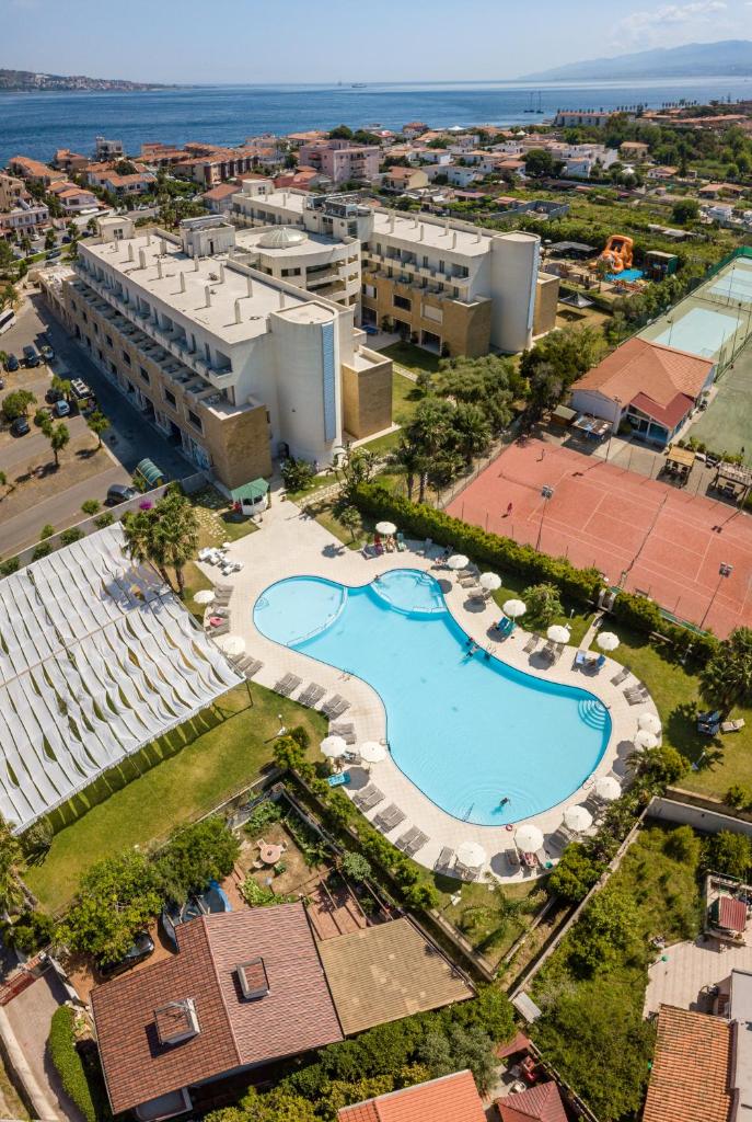 une vue aérienne d'un complexe hôtelier avec piscine dans l'établissement Capo Peloro Hotel, à Torre Faro