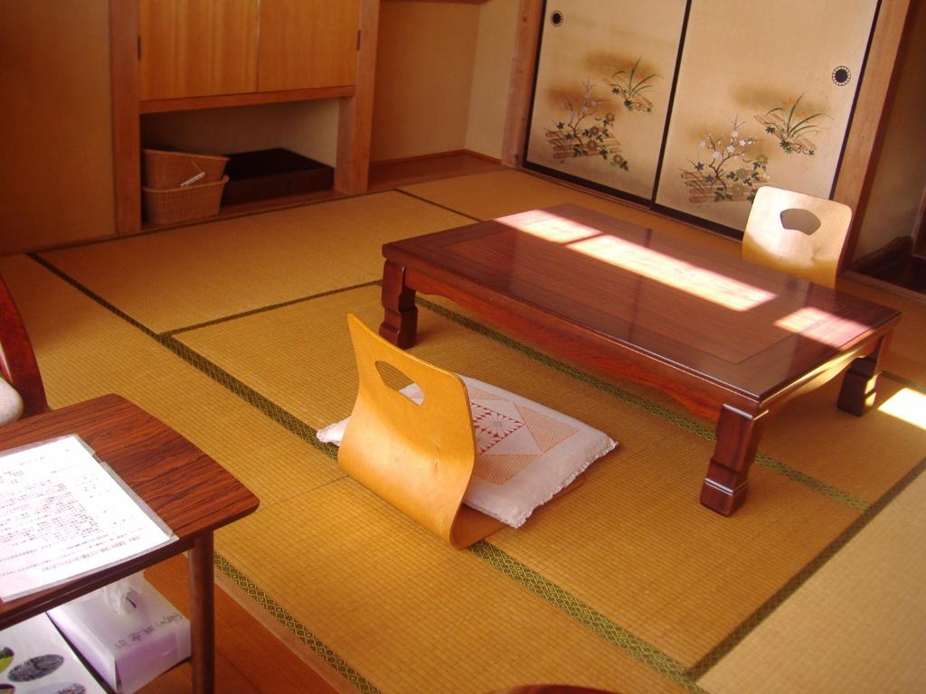 - un salon avec une table basse et une table sidx sidx dans l'établissement Ishibu-so, à Matsuzaki
