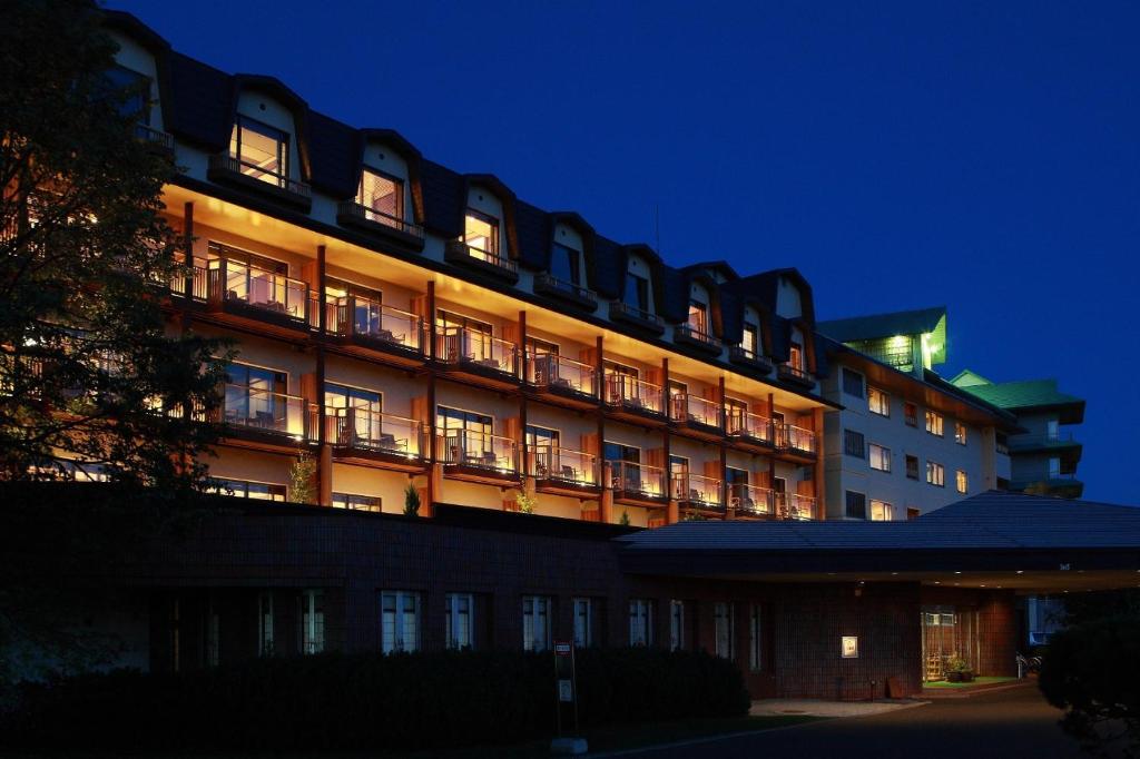 un grand bâtiment d'hôtel avec ses lumières allumées la nuit dans l'établissement Tokachigawa Onsen Daiichi Hotel, à Otofuke