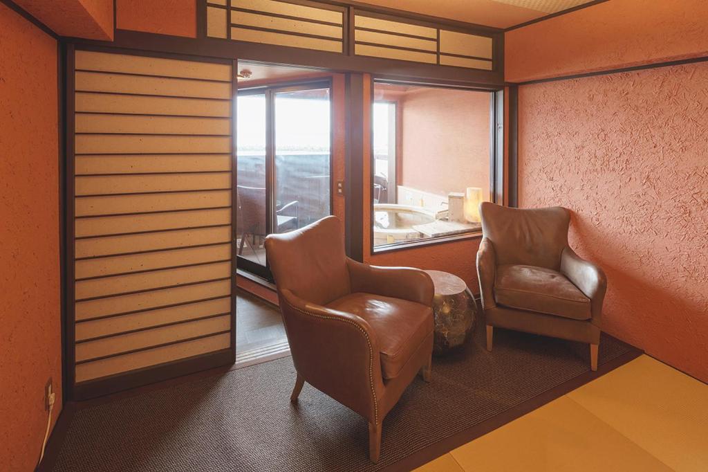 - une salle d'attente avec 2 chaises et une fenêtre dans l'établissement Arujisu, à Izu