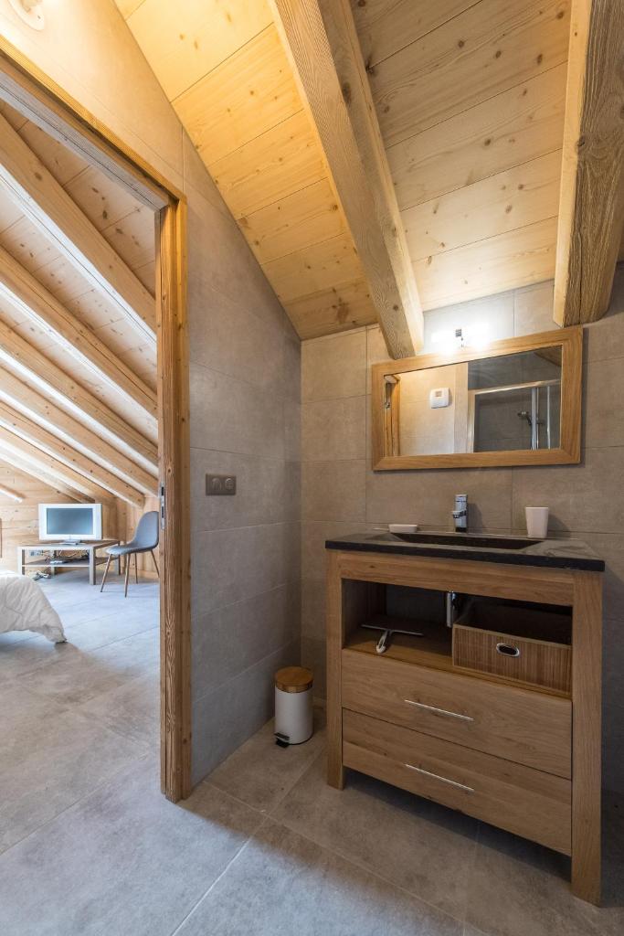 - une chambre avec lavabo et miroir dans l'établissement ODYSSEE B301 Duplex mansarde sur les pistes, vue panoramique, à La Toussuire 7 autres photos