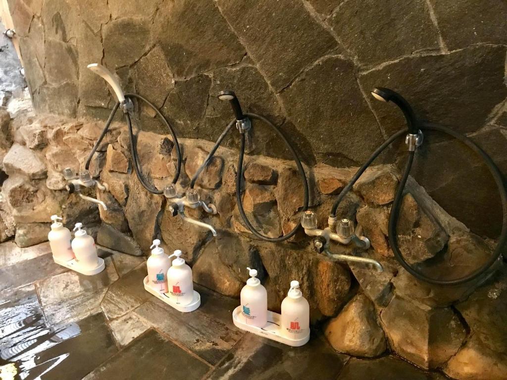 un groupe de bouteilles de blanchiment suspendues sur un mur dans l'établissement Tsukinoya, à Hakone 35 autres photos