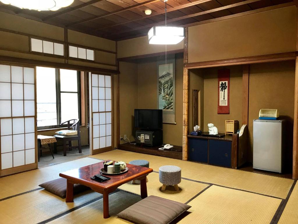 un salon avec une table et un réfrigérateur dans l'établissement Tsukinoya, à Hakone