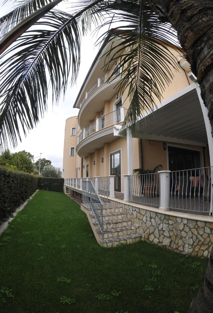 un bâtiment avec un palmier devant dans l'établissement Gullo Hotel, à Curinga