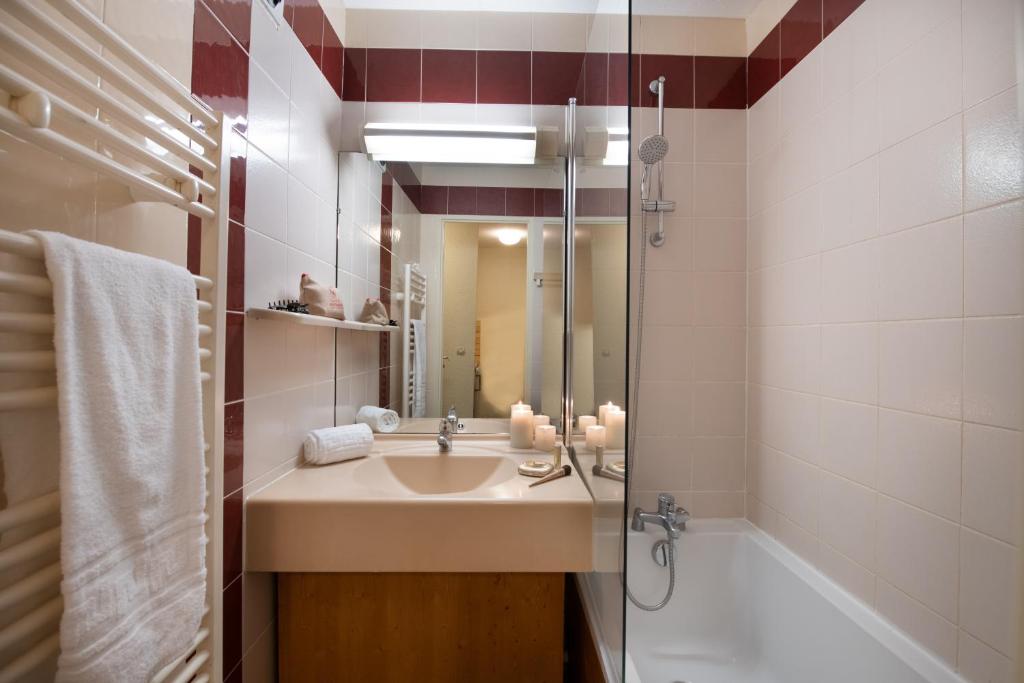 une salle de bain avec un lavabo et une douche dans l'établissement Le Cheval Blanc - Village Montana, à Val Thorens