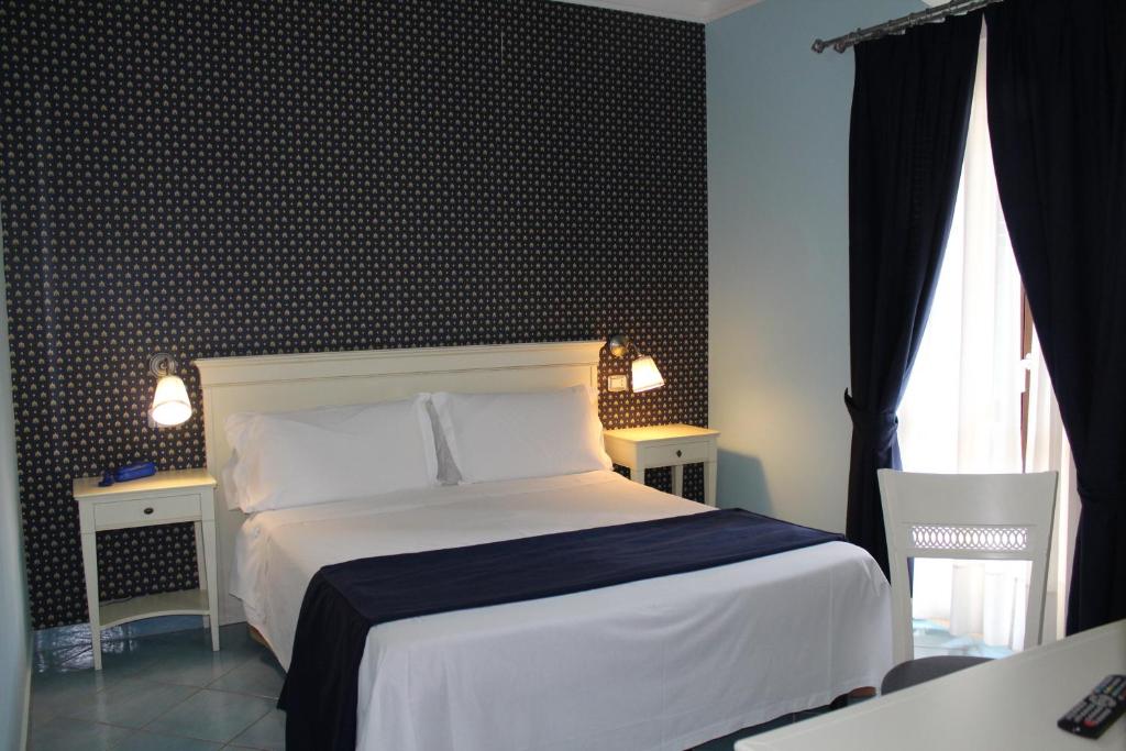 une chambre avec un lit et deux tables et une fenêtre dans l'établissement Parco Dei Principi, à Paestum 51 autres photos