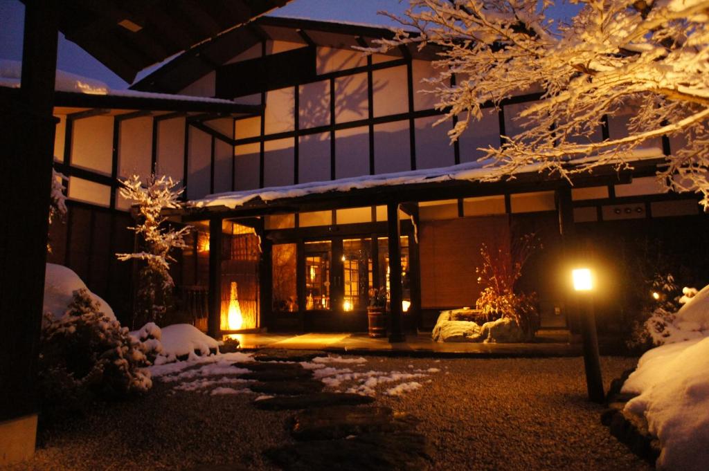 une maison avec de la neige au sol la nuit dans l'établissement Hidaji (Adult Only), à Takayama 37 autres photos