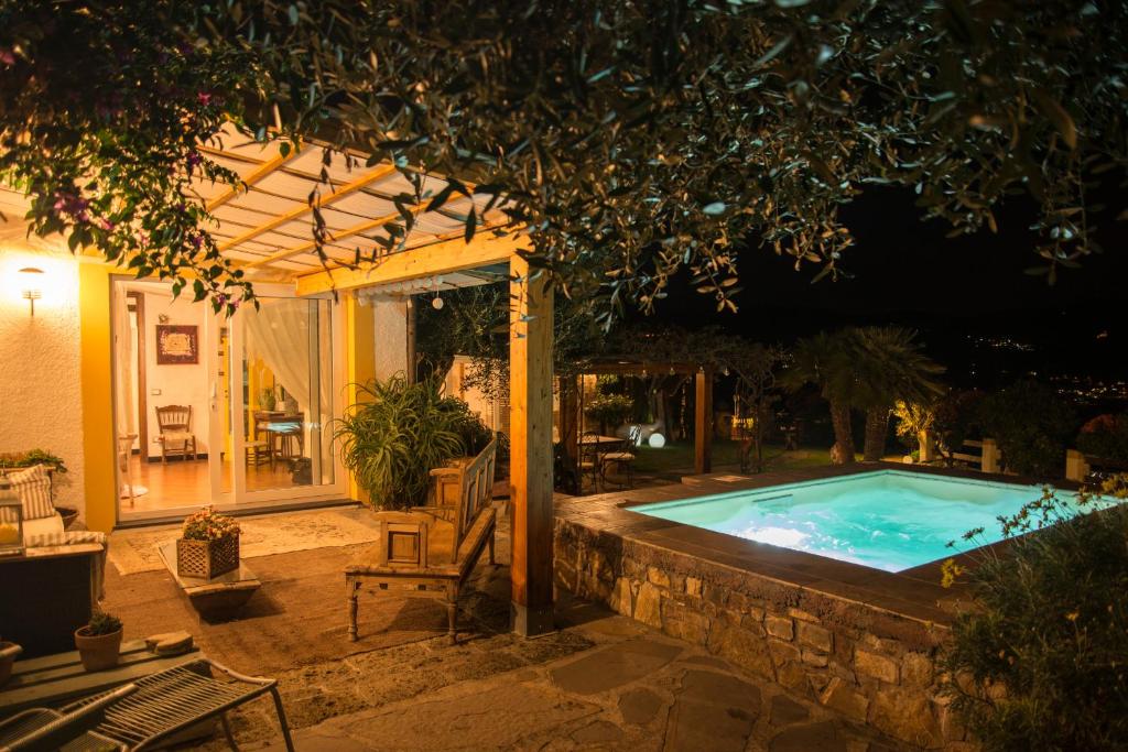 une piscine dans un jardin la nuit dans l'établissement Villa Annetta, à Poggi
