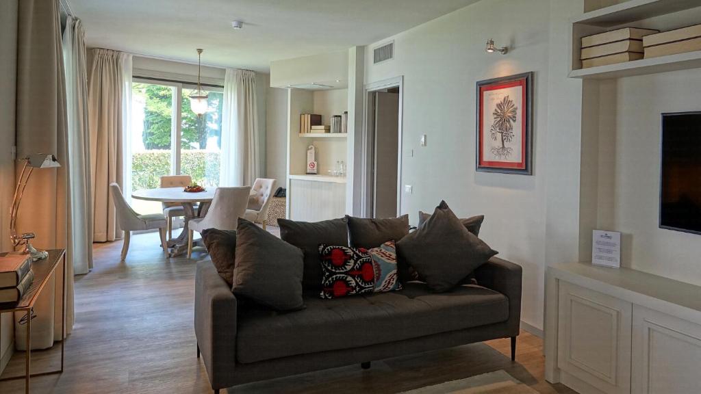 un salon avec un canapé et une table dans l'établissement Splendido Bay Luxury Spa Resort, à Padenghe sul Garda