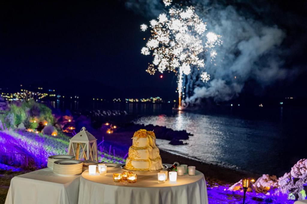 - une table avec un gâteau de mariage et des feux d'artifice dans l'établissement Hotel Sporting, à Porto Rotondo 103 autres photos