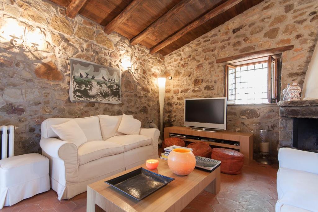 un salon avec un canapé et une télévision dans l'établissement Relax at the Swimming Pool by Wonderful Italy, à Cefalù 27 autres photos