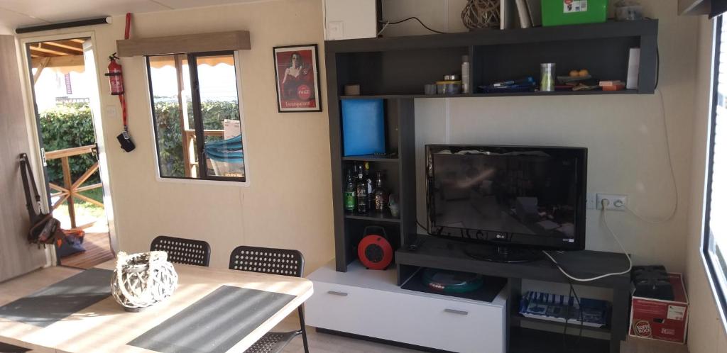 - un salon avec une télévision et une table dans l'établissement SIBLU CONDRIEU, à Condrieu