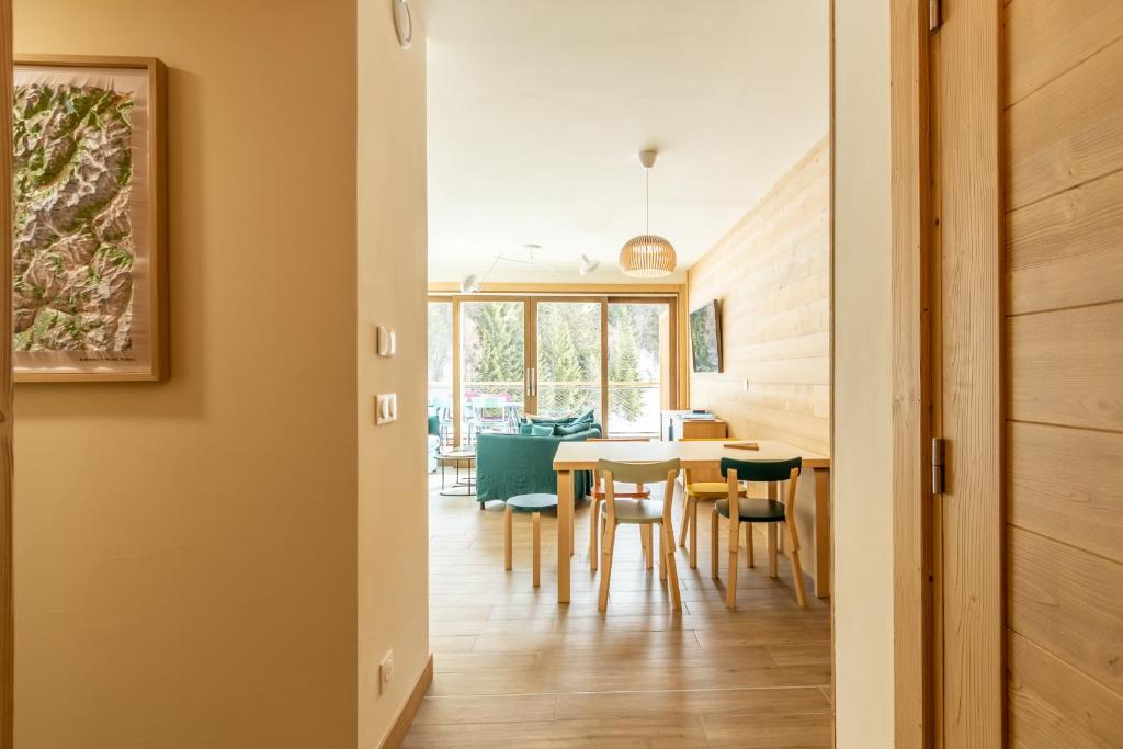 une salle à manger et une cuisine avec une table et des chaises dans l'établissement LE RIDGE Appartement Premium - Les Arcs Paradiski, à Arc 1600