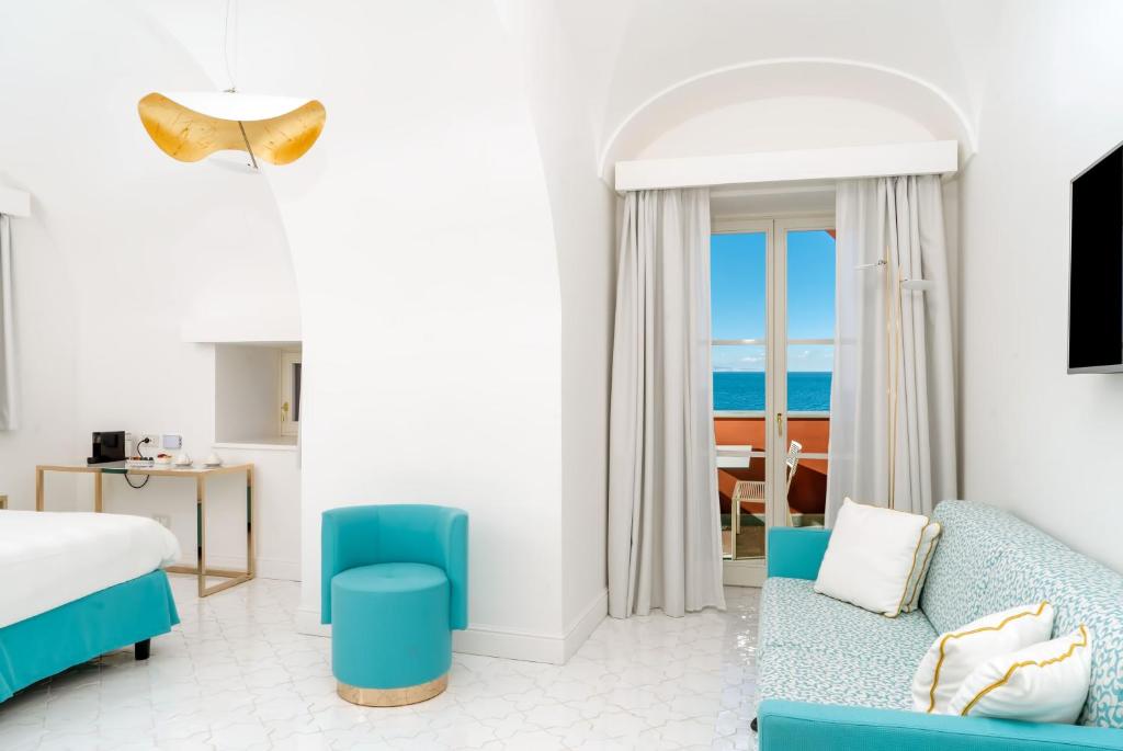 - une chambre avec un lit et une chambre avec vue sur l'océan dans l'établissement Hotel Lorelei Londres, à Sorrente