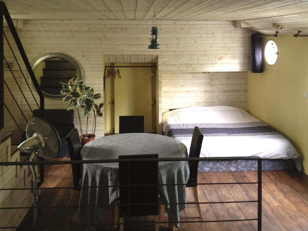 une pièce avec un lit et une table dedans dans l'établissement Boat For Guest, à Issy-les-Moulineaux
