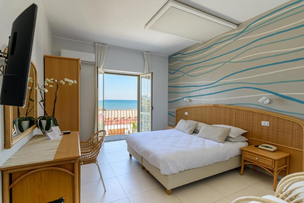 une chambre avec un lit et une vue sur l'océan dans l'établissement Hotel Mandetta - Adults Only, à Paestum