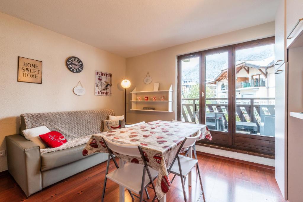 un salon avec une table et un canapé dans l'établissement Vue magique en hypercentre avec parking privatif, à Chamonix-Mont-Blanc
