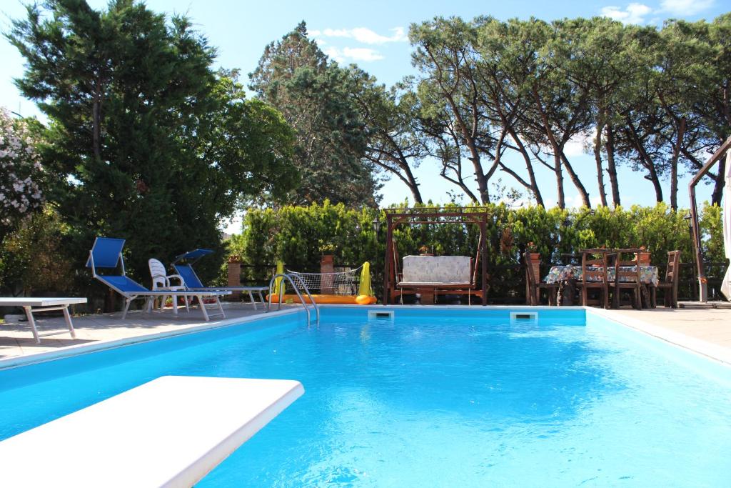 une piscine bleue avec des chaises et une aire de jeux dans l'établissement Villa delle Rose, à Boscotrecase