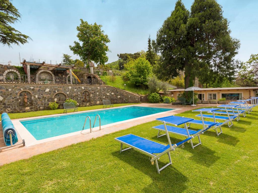 une rangée de chaises longues bleues à côté d'une piscine dans l'établissement Villa Vista da Rocca di Papa-2 by Interhome, à Rocca di Papa