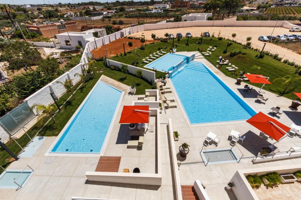 une vue aérienne de deux piscines avec parasols dans l'établissement Seawater Hotel Bio & Beauty Spa, à Marsala
