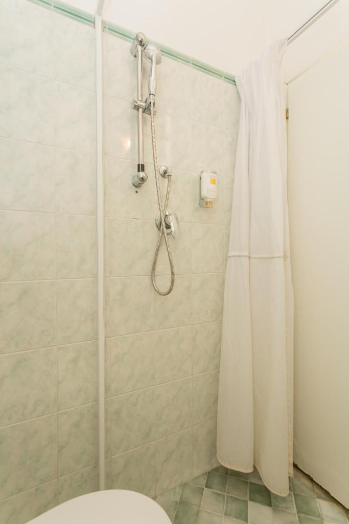 La salle de bains est pourvue d'une douche, de toilettes et d'un rideau de douche. dans l'établissement Hotel Delle Nazioni - Valentini Family Village, à Bellaria-Igea Marina
