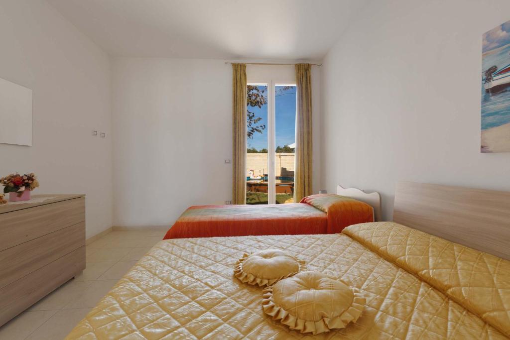 une chambre avec deux lits avec des cœurs dessus dans l'établissement Villa Il Fenicottero Salentino by BarbarHouse, à San Pietro in Bevagna