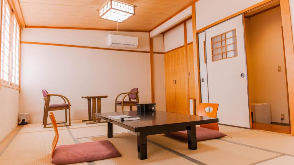 un salon avec une table et des chaises dans l'établissement Yuzennoyado Toukai, à Ureshino