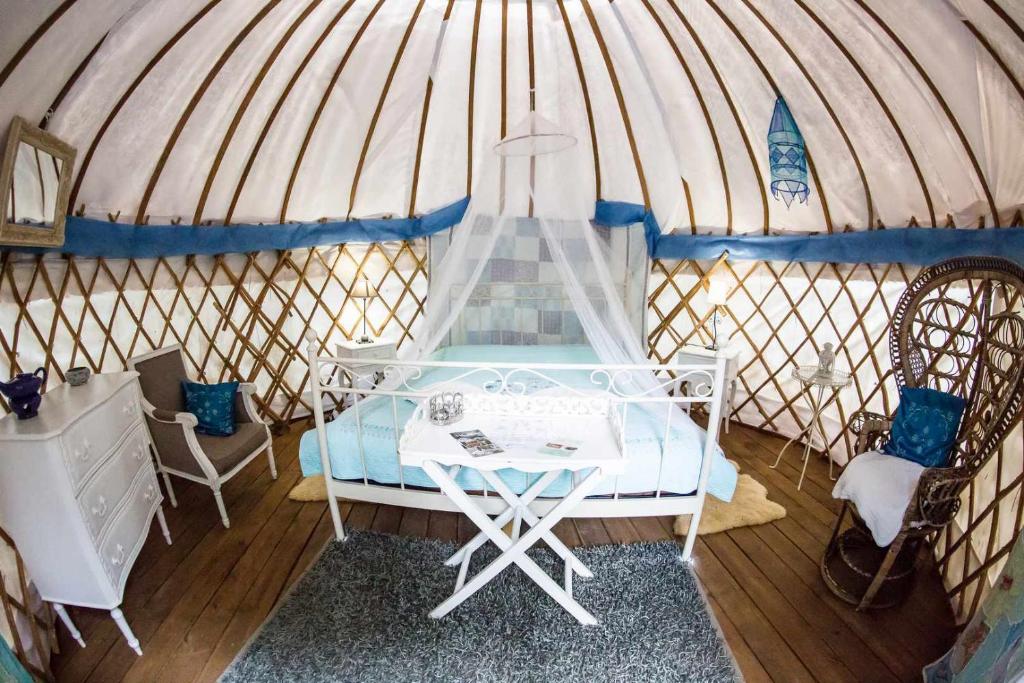 - une chambre avec un lit dans une yourte dans l'établissement Camping Mille Étoiles, à Labastide-de-Virac