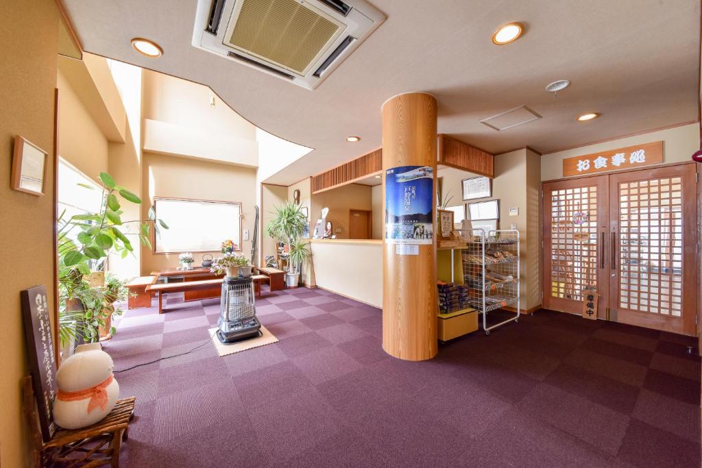 une grande chambre avec une colonne au milieu dans l'établissement Kanoe, à Iiyama