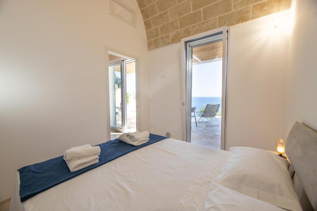 une chambre avec un lit avec vue sur l'océan dans l'établissement Tenuta Marinaia, à Marittima