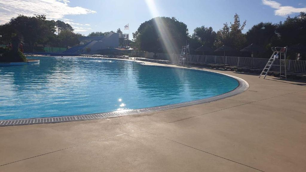 - une grande piscine avec une échelle à côté dans l'établissement 3 chambres mimizan gastes biscarrosse camping siblu, à Gastes 8 autres photos