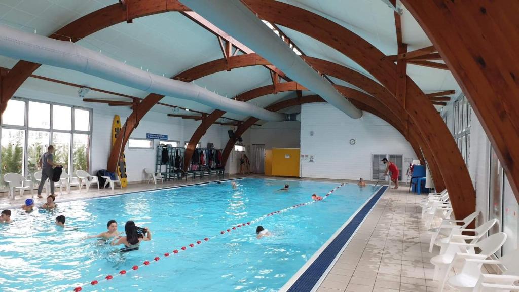un groupe de personnes dans une piscine dans l'établissement 3 chambres mimizan gastes biscarrosse camping siblu, à Gastes