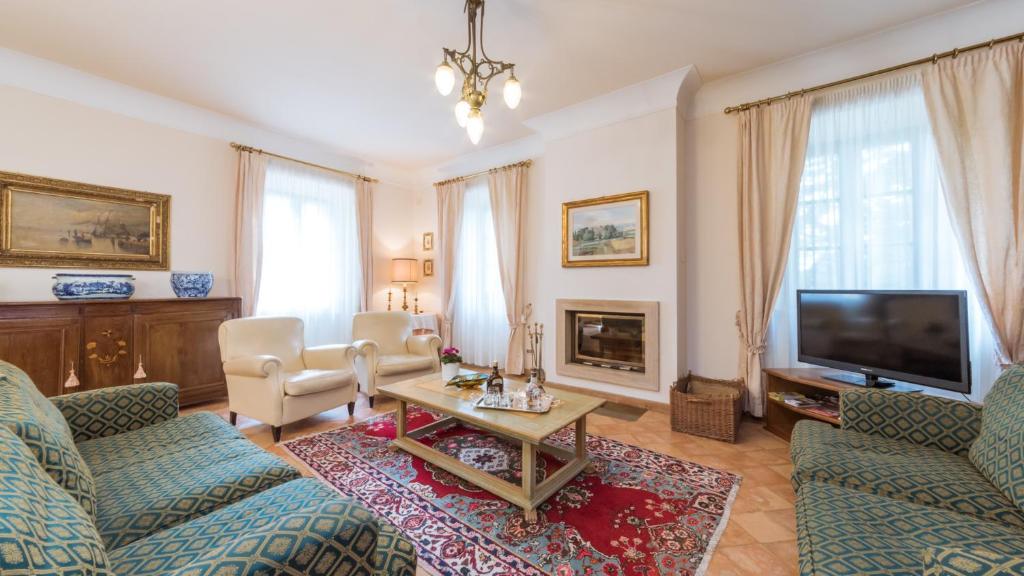 un salon avec deux canapés et une télévision dans l'établissement BORGO COLLE RIDENTE 13, Emma Villas, à Camerino