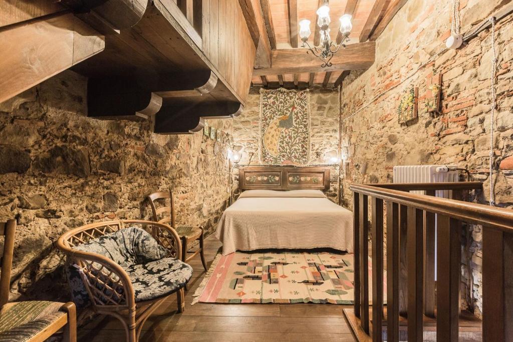 une chambre avec un lit dans un mur de pierre dans l'établissement Torre Del Cielo, à Monterchi