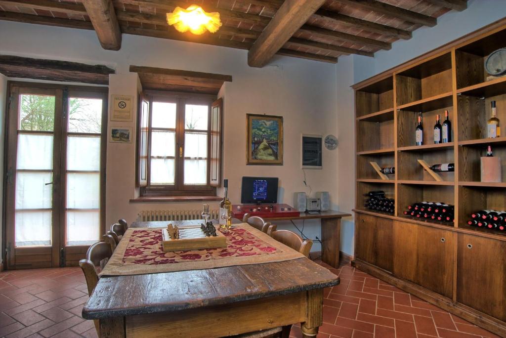 une grande pièce avec une grande table en bois avec des chaises dans l'établissement Villa Il Prato, à San Pancrazio