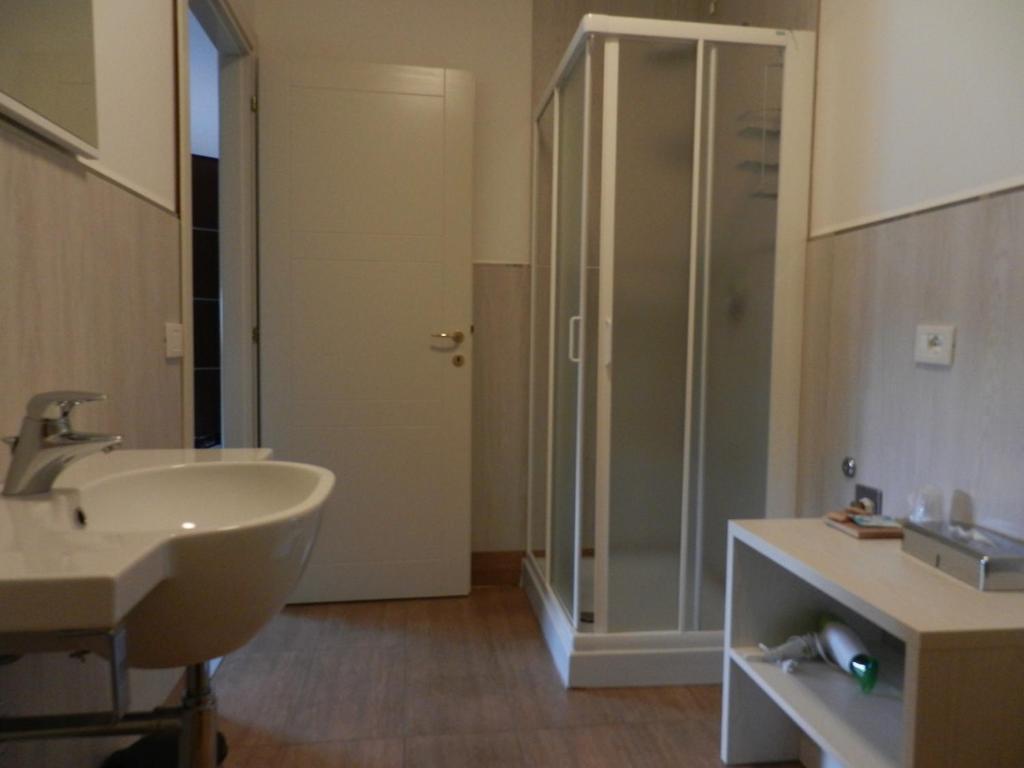 une salle de bain avec un lavabo et une douche en verre dans l'établissement Hotel Giulio Cesare, à Rimini 43 autres photos