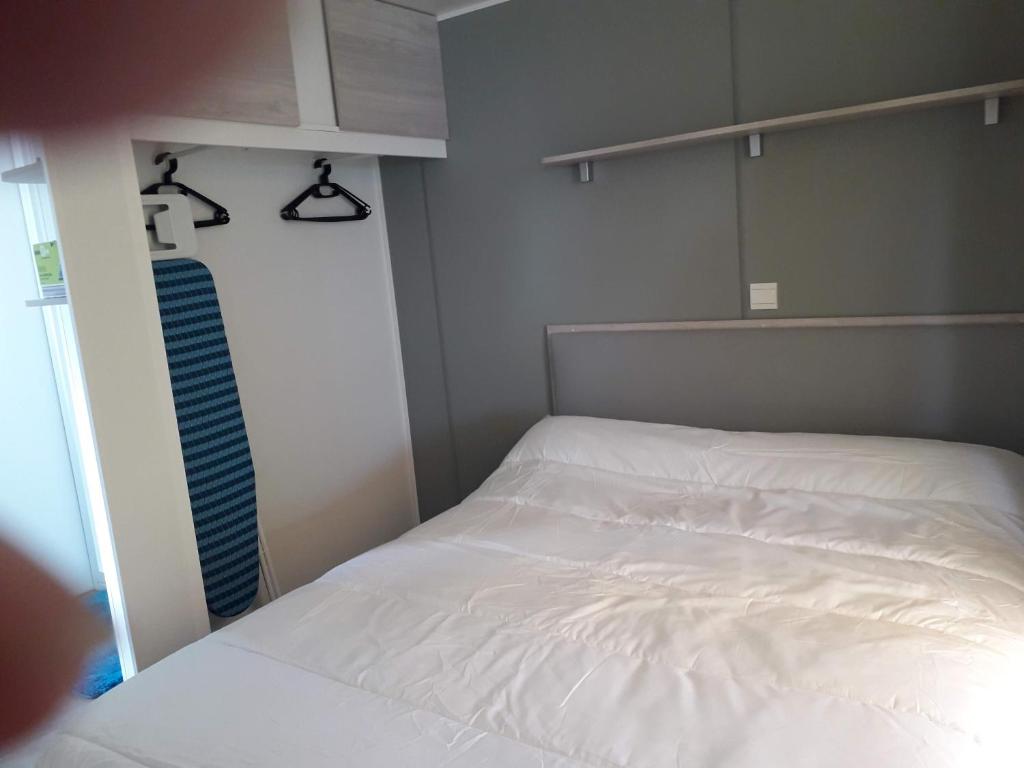 - une petite chambre avec un lit blanc et un placard dans l'établissement mobil home neuf 2 chambres 6 personnes Saint Aygulf plage, à Fréjus 29 autres photos