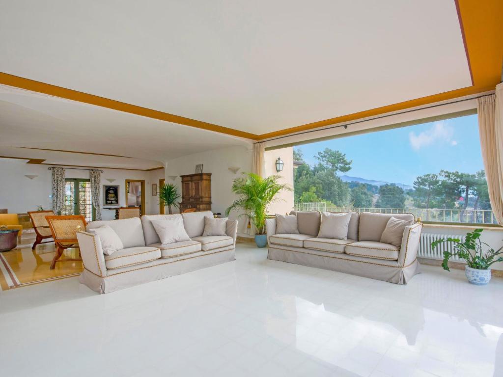 un salon avec deux canapés et une grande fenêtre dans l'établissement Villa Delfina by Interhome, à Montignoso