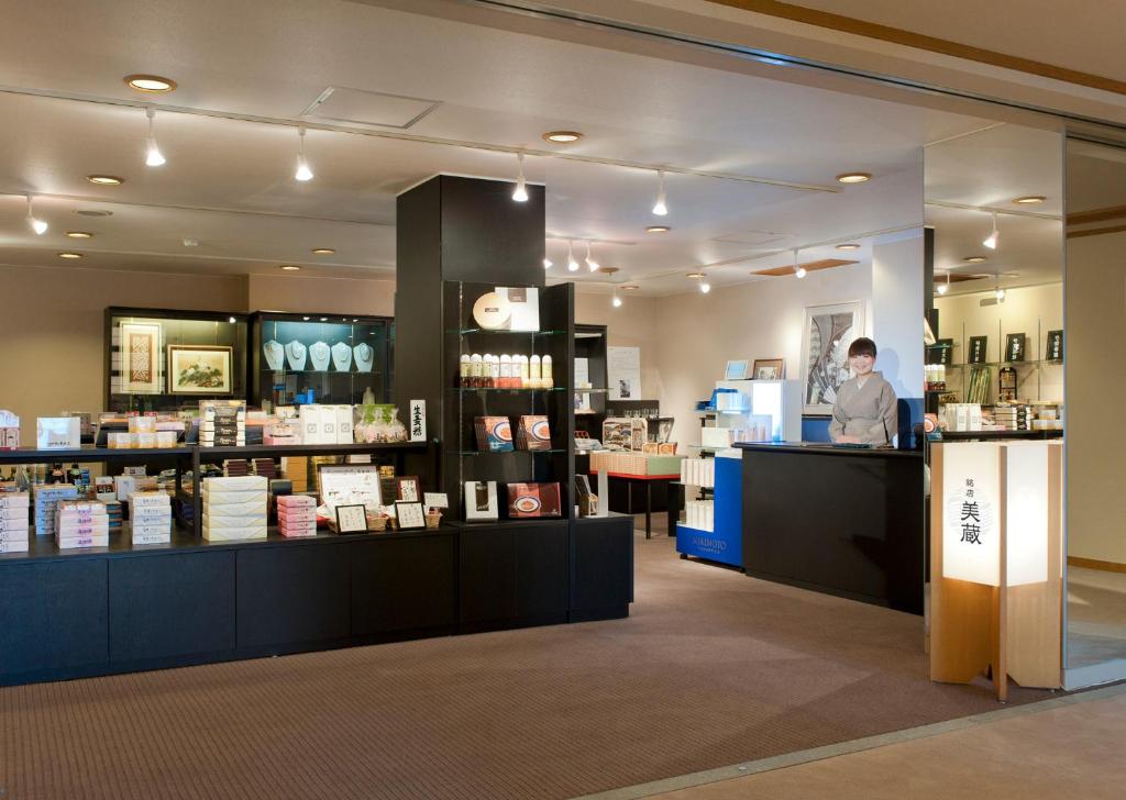 un homme debout à un comptoir dans un magasin dans l'établissement Toba International Hotel Shiojitei, à Toba